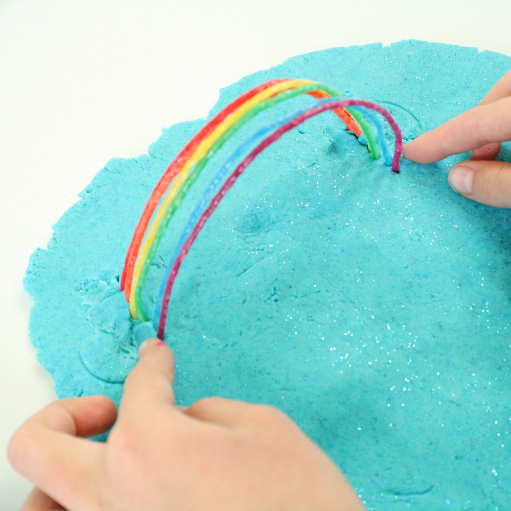 Building a rainbow with Wikki Stix and Play Dough
