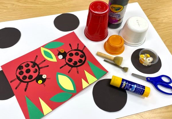 Materials and finished example of ladybug craft for kids