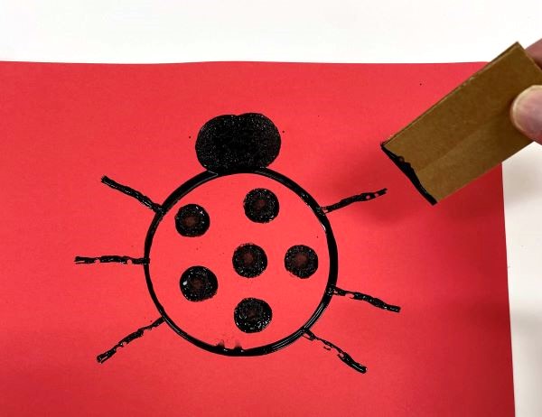Step 3-Add leg to ladybug art project for kids